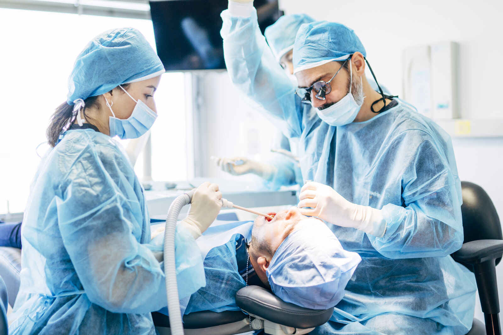 Oral Surgeons Performing Work on Patient