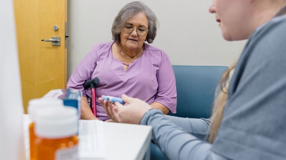 Pharmacist consulting with a patient about medication use at the Chickasaw Nation Department of Health, highlighting personalized care and patient education in pharmacy practice.