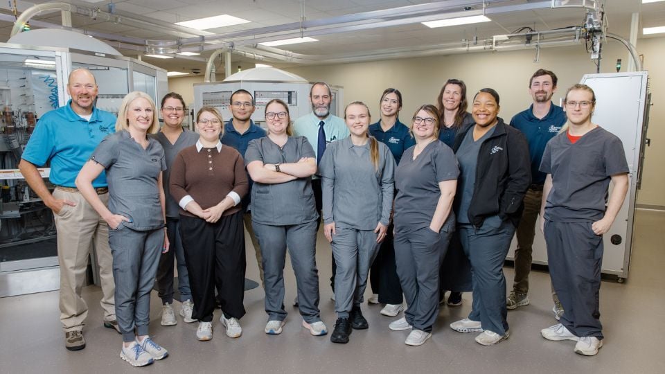 Pharmacy team members from the Chickasaw Nation Department of Health standing together inside a pharmacy workspace, representing collaboration and mentorship within the PGY1 Pharmacy Residency Program