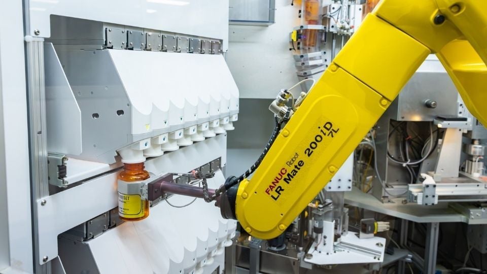 Automated pharmacy robot dispensing a prescription bottle at the Chickasaw Nation Department of Health, demonstrating advanced technology and innovation in medication management.